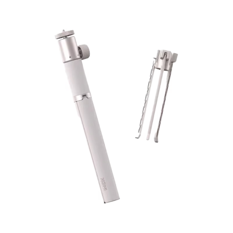 A white handheld electric toothbrush shown alongside its charging cable and a small accessory on a plain white background.