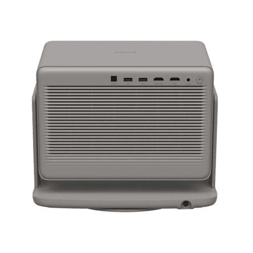 A compact, rectangular electronic device in a matte gray finish, featuring a front grille, multiple ports on the top, and a small circular button on the front right, shown on a plain white background.